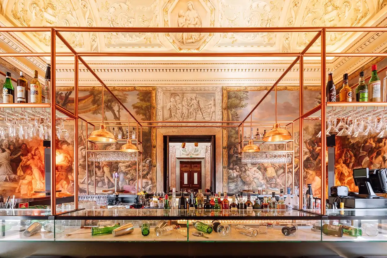 The ornate bar beneath sculpted ceilings and painted walls