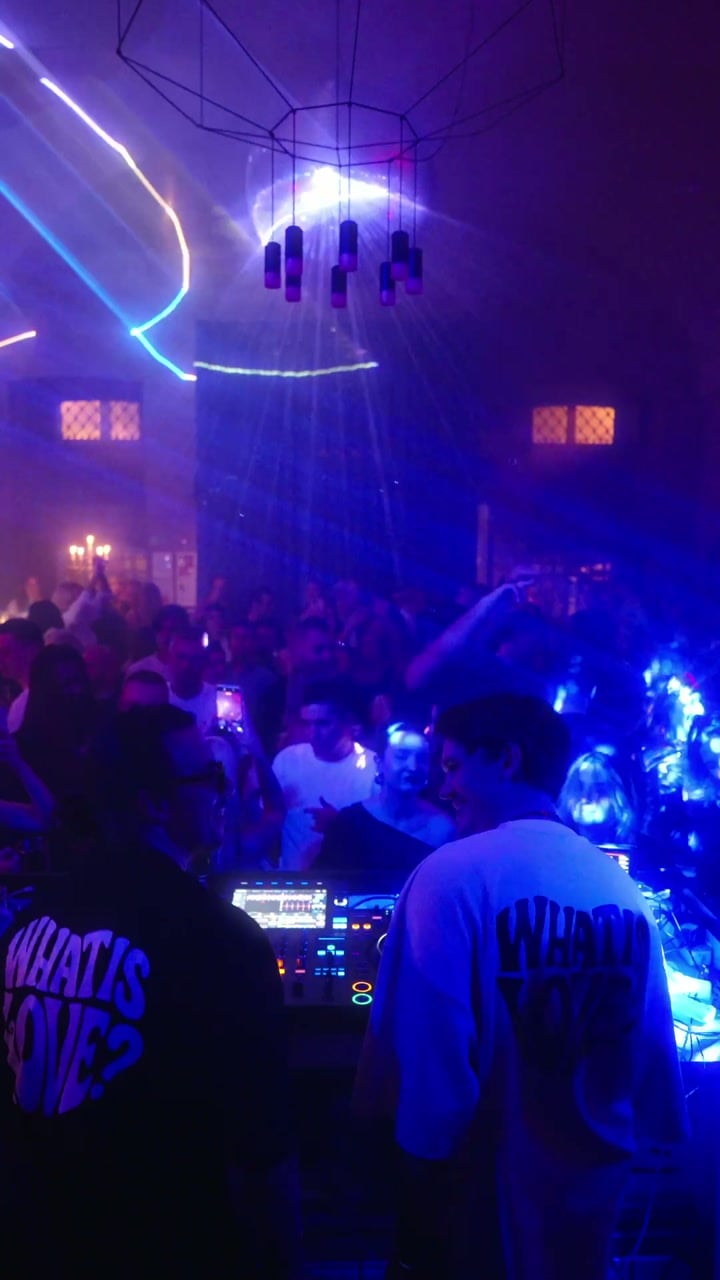 Moon Summit DJs overlooking a packed dance floor under colourful lights
