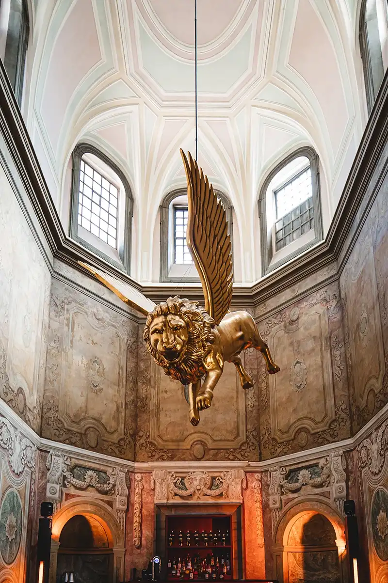 The golden winged lion beneath the vaulted ceiling of the palace’s grand staircase